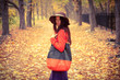 fashion girl standing in the autumn forest
