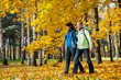 Happy young couple with backpacks in the park