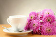 Photo: cup and a bouquet of beautiful flowers cup and a bouquet of beautiful flowers
