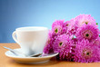Photo: cup and a bouquet of beautiful flowers cup and a bouquet of beautiful flowers