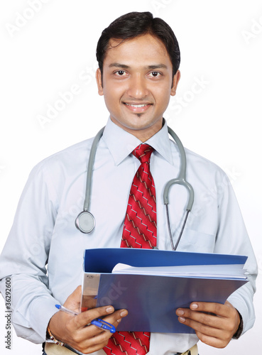 Photo: Portrait of Indian Doctor with Reports Portrait of Indian Doctor with Reports