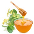 Linden honey is pouring with sticks in a jar