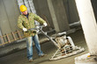 Worker trowelling and finishing of concrete Worker trowelling and finishing of concrete