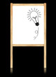 bulb idea on whiteboard with wooden frame  isolate on black
