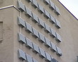 Building wall fragment with lof of solar collectors.