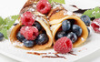 pancakes topped with blueberries,raspberries, mint and Powdered pancakes topped with blueberries,raspberries, mint and Powdered