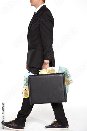 Photo: businessman carrying suitcase full of money businessman carrying suitcase full of money