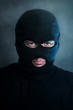 Burglar in black balaclava at night