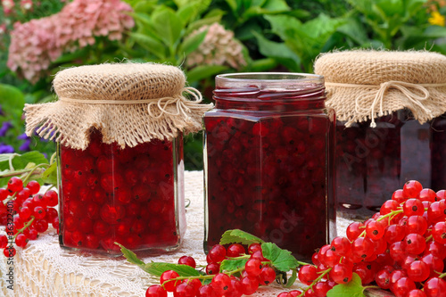 Photo: Jars of homemade red currant jam with fresh fruits Jars of homemade red currant jam with fresh fruits