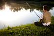 Man fishing in a pond. Back view. Shallow DOF.