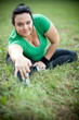Happy overweight woman stretching in a park. Shallow DOF.