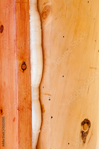 Photo: Polyurethane foam seals gap in wood construction Polyurethane foam seals gap in wood construction