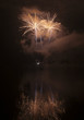 Colorful fireworks on black sky background with water reflection Colorful fireworks on black sky background with water reflection