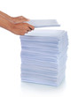 hand put paper on stack of paper.