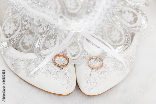 Photo: Wedding garter, white shoes and rings Wedding garter, white shoes and rings