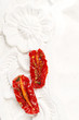 sun-dried tomatoes with olive oil in an old  white wooden backgr