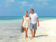 Mature couple strolling by the beach