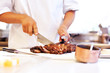 Professional chef cutting roasted meat Professional chef cutting roasted meat