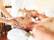 Relaxed couple having head massage in day spa