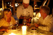 Senior couple at restaurant having candle light dinner
