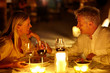 Mature couple enjoying candlelight dinner in a restaurant