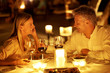 Mature couple enjoying candlelight dinner in a restaurant