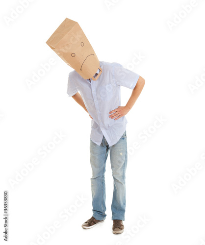 Photo: man with sad ecological paper bag on head, full length man with sad ecological paper bag on head, full length