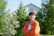 Happy woman posing in front of residence Happy woman posing in front of residence