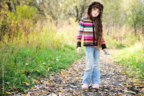 Photo: Funky child posing outdoors in colorful blouse Funky child posing outdoors in colorful blouse