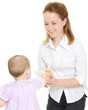 The woman gives the baby a bottle of infant formula.