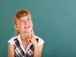 Schoolchild near green blackboard.