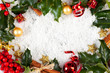 christmas card with holly, cinnamon,ribbon, baubles and gifts