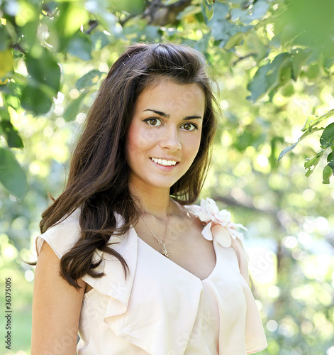 Photo: Portrait of smiling beautiful girl in the autumn morning park Portrait of smiling beautiful girl in the autumn morning park