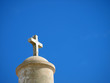 Stone cross on the top of an old church