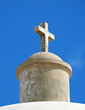 Stone cross on the top of an old church