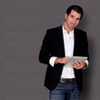 Smiling man standing on dark background