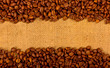 Coffee grains on the burlap background
