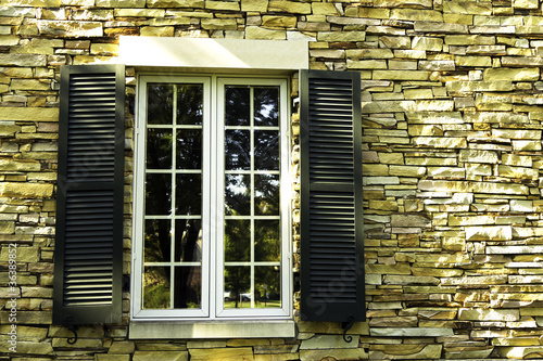 Photo: Window in a stone wall with shutters Window in a stone wall with shutters