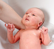 newborn baby bath in white bathtub by mother newborn baby bath in white bathtub by mother