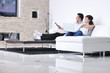 Photo: Relaxed young couple watching tv at home Relaxed young couple watching tv at home
