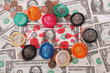 A bloodstained one-dollar bill and colored condoms