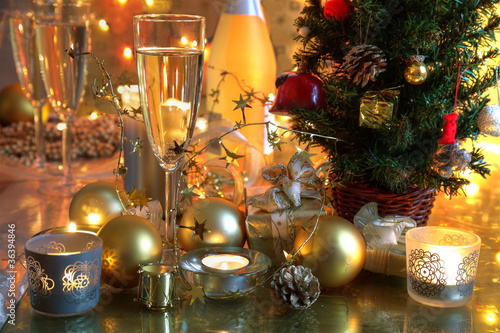 Photo: Champagne,baubles,candle lights and christmas tree. Champagne,baubles,candle lights and christmas tree.