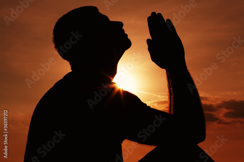 Photo: Praying man silhoutte Praying man silhoutte