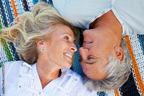 Photo: Portrait of a happy romantic couple outdoors. Portrait of a happy romantic couple outdoors.