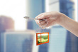 Hand holding key with keychain in the shape of window