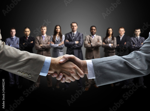 Photo: handshake isolated on business background handshake isolated on business background