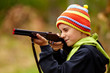 Boy playing with toy shotgun