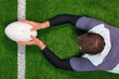 Rugby player scoring a try with both hands.