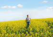Photo: Man runs through the canola field Man runs through the canola field