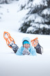 Portrait of the hiker lying in snow